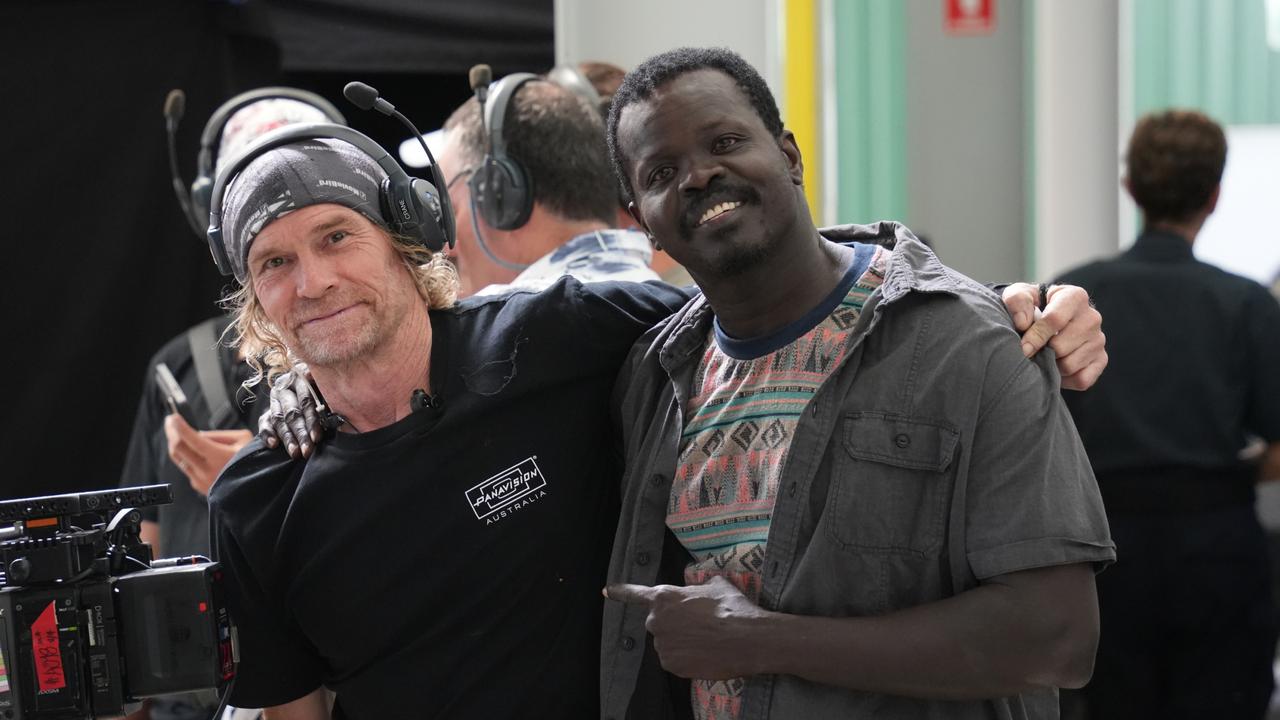 On the set of the Australian independent film Spit, a sequel to 2003 classic Gettin' Square, at the Queensland Regional Accommodation Centre near Toowoomba Wellcamp Airport. Actor Ayik "Daniel" Chut Deng with a member of the crew.