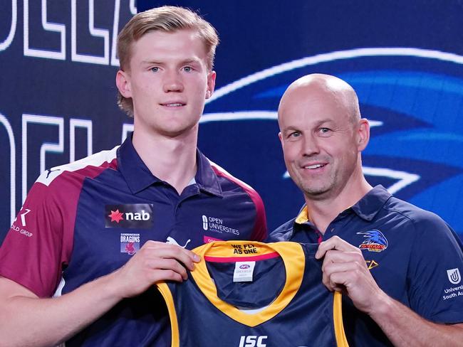 Sixth AFL Draft pick Fischer McAsey is presented with a jersey by Adelaide Crows coach Mathew Nicks during the first round of the 2019 AFL Draft at Marvel Stadium in Melbourne, Wednesday, November 27, 2019. (AAP Image/Michael Dodge) NO ARCHIVING