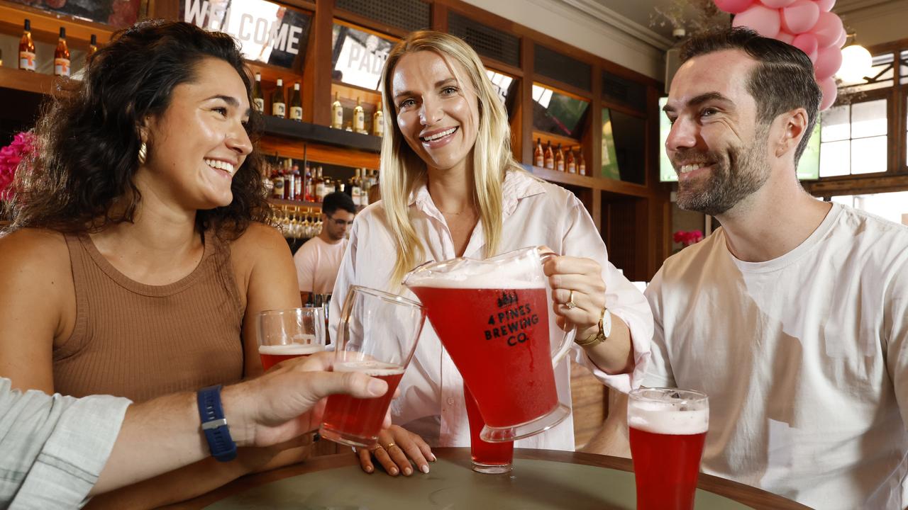 Jennifer Schweser, Victoria Day and Tom Burns try the Pink Beer specially brewed for Pink Day at the Sydney Test against Pakistan. Picture: Richard Dobson