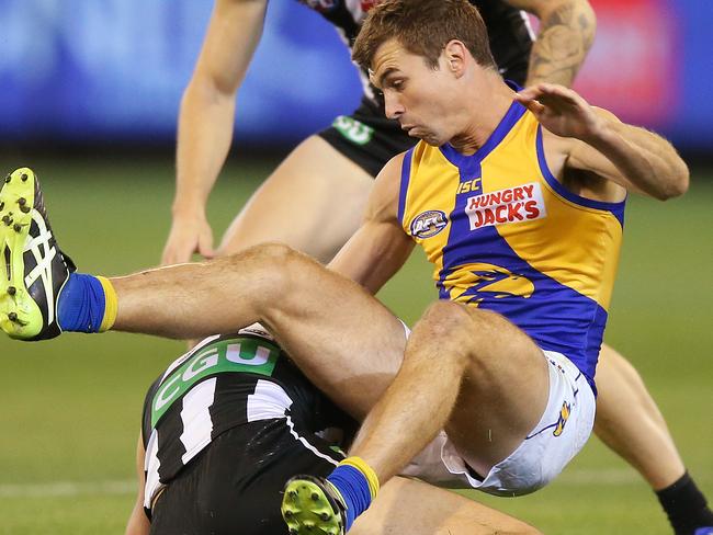 MELBOURNE, AUSTRALIA - APRIL 06: Jamie Cripps of the Eagles receives a free kick after Tom Phillips of the Magpies slides in during the round three AFL match between the Collingwood Magpies and the West Coast Eagles at Melbourne Cricket Ground on April 06, 2019 in Melbourne, Australia. (Photo by Michael Dodge/Getty Images)