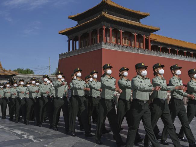 BEIJING, CHINA - MAY 20: Soldiers of the People's Liberation Army's Honour Guard Battalion march outside the Forbidden City, near Tiananmen Square, on May 20, 2020 in Beijing, China. China's government will open its annual weeklong meetings known as the 'two sessions' at the Great Hall of the People on May 21st. They were delayed in March due to the COVID-19 pandemic. After decades of growth, officials recently said China's economy had shrunk in the latest quarter due to the impact of the coronavirus epidemic. The slump in the worlds second largest economy is regarded as a sign of difficult times ahead for the global economy. While industrial sectors in China are showing signs of reviving production, a majority of private companies are operating at only 50% capacity, according to analysts. With the pandemic hitting hard across the world, officially the number of coronavirus cases in China is dwindling, ever since the government imposed sweeping measures to keep the disease from spreading. Officials believe the worst appears to be over in China, though there are concerns of another wave of infections as the government attempts to reboot the worlds second largest economy. Since January, China has recorded more than 82,000 cases of COVID-19 and at least 4000 deaths, mostly in and around the city of Wuhan, in central Hubei province, where the outbreak first started. (Photo by Kevin Frayer/Getty Images)