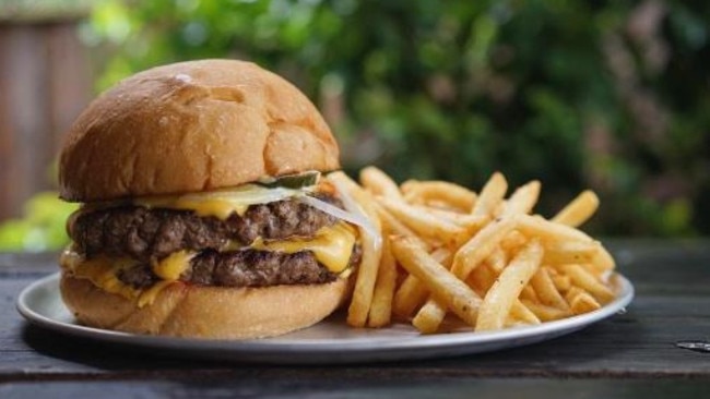 The double cheeseburger with two beef patties, pickles, cheese, onions, sweet mustard and ketchup served with old bay fries ($15). Picture: The Tuckshop