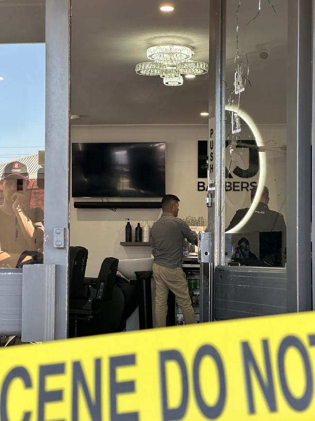 KJ Barbers had four bullet holes through the glass of its front door. Picture: Sam Lowe