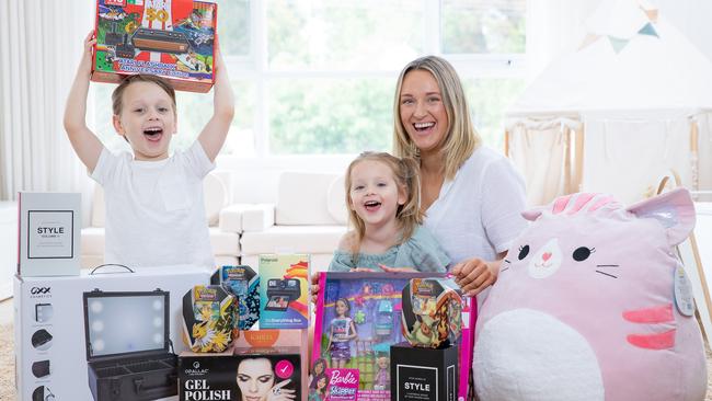 Josie Barber and her two kids, Flynn, 4, and Lilah, 2, with top products from Kmart. Picture: Jason Edwards