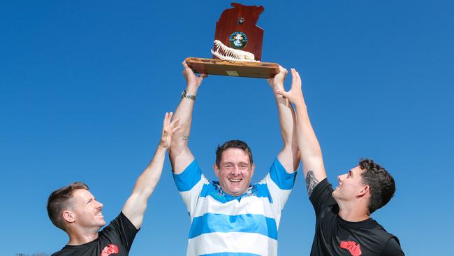 US Marine Grant Penny, left Stray Cats Peter Meyer and US Marine Jake Hitchings play keepings off with the Crocodile trophy up for grabs in the annual US Marines v Casuarina Stray Cats commemorative game. Picture GLENN CAMPBELL