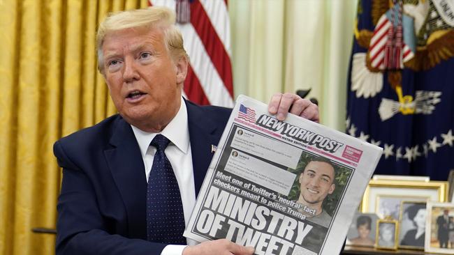 President Donald Trump holds up a copy of the New York Post before signing an executive order aimed at curbing protections for social media giants. Picture: AP