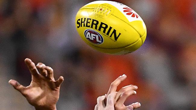 Generic picture of hands competing for the ball during the round 5 AFL match between the Gold Coast Suns and the North Melbourne Kangaroos at Metricon Stadium on the Gold Coast, Saturday, April 23, 2016. (AAP Image/Dave Hunt) NO ARCHIVING, EDITORIAL USE ONLY