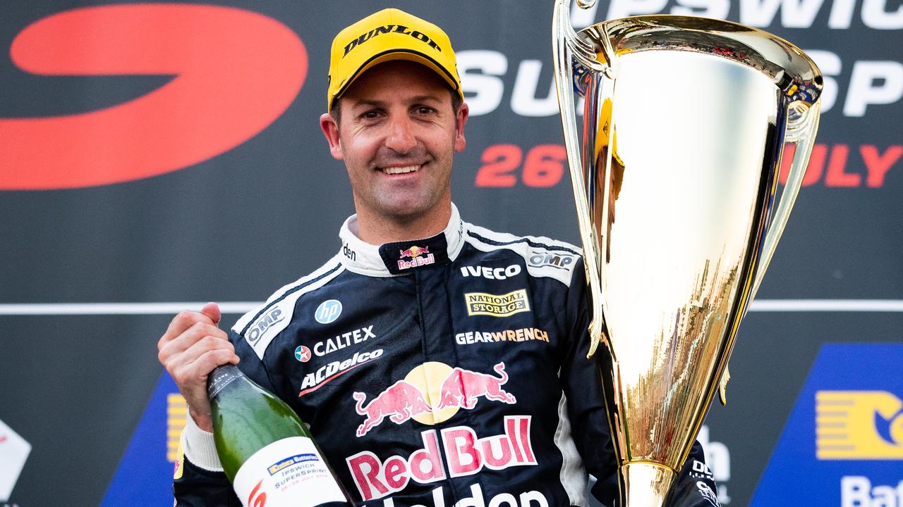 Jamie Whincup celebrates on the podium during Race 19 for the Ipswich SuperSprint.