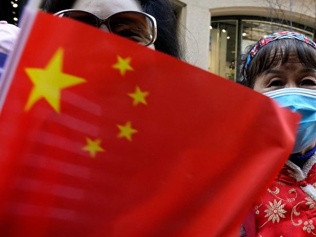 Protestors look on as Taiwan's President Tsai Ing-wen, not pictured, arrives at her hotel in New York City on March 29, 2023, as she begins a ten-day international trip. - Taiwan's President Tsai Ing-wen arrived in New York for a visit that has triggered threats of reprisal by China if she meets with House speaker Kevin McCarthy -- and US warnings for Beijing not to overreact. (Photo by TIMOTHY A. CLARY / AFP)