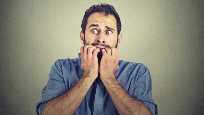 Portrait anxious young man biting his nails fingers freaking out, frightened, generic, scared