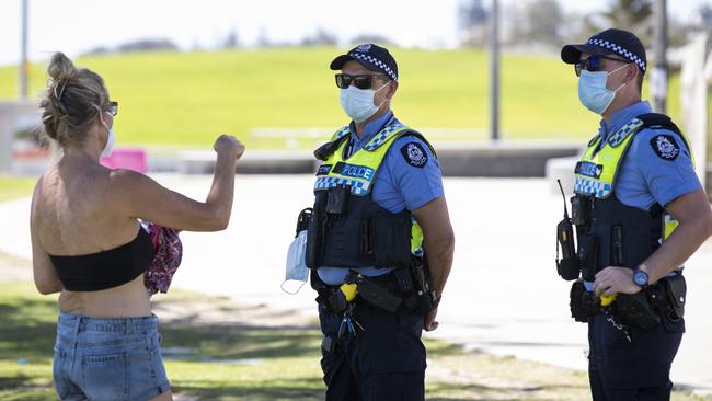 Police are seen speaking to a member of the public in Perth amid the WA lockdown. Picture: Getty Images