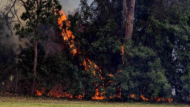 Smoke haze covers the Gold Coast Skyline  from a grass fire at Carrara. Emergency services at St Michael's Collage, Merrimac. Fire burning near the school oval.  Picture: Jerad Williams