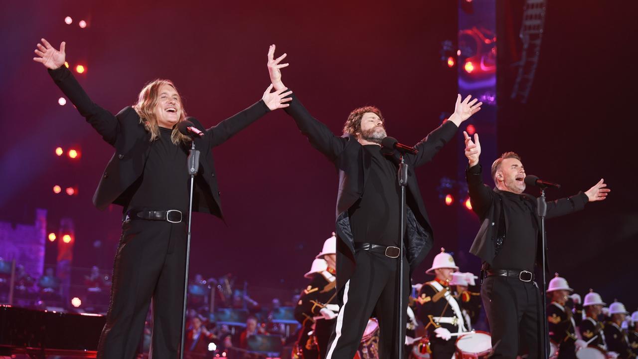 Take That circa 2024 (L-R): Mark Owen, Howard Donald and Gary Barlow on stage. Picture: Chris Jackson/Getty