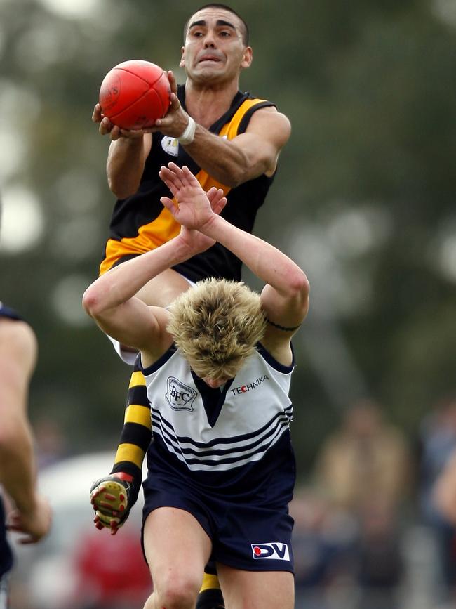 Justin Murphy flies over David Mitchell. Picture: Andrew Brownbill