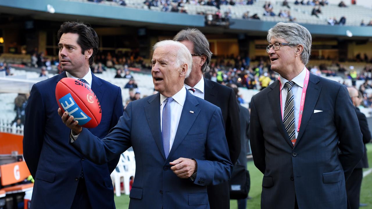 Biden possibly contemplating a handball, alongside Gillon McLachlan (left) and Mike Fitzpatrick (right). (Photo by Tracey Nearmy – Pool/Getty Images)