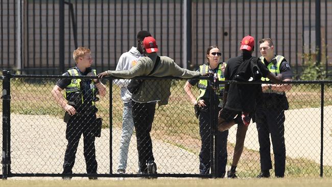 Police speak to African youths outside the Ecoville Community Park in Tarneit.