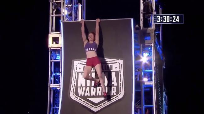 Female ninja pulls of crazy move to get up the warped wall