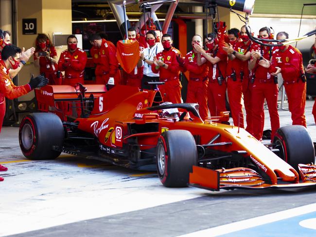 The Ferrari team applaud as Sebastian Vettel leaves the garage for his final race with the team.