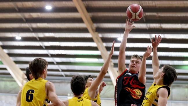 Mildura’s Ned Oldhams hoots the ball over the defence during the under-18 division one grand final at the SA Country Basketball Championships at Wayville on Monday. The clash was one of 25 grand finals live streamed by The Advertiser. Picture: Kelly Barnes/AllStar Photos