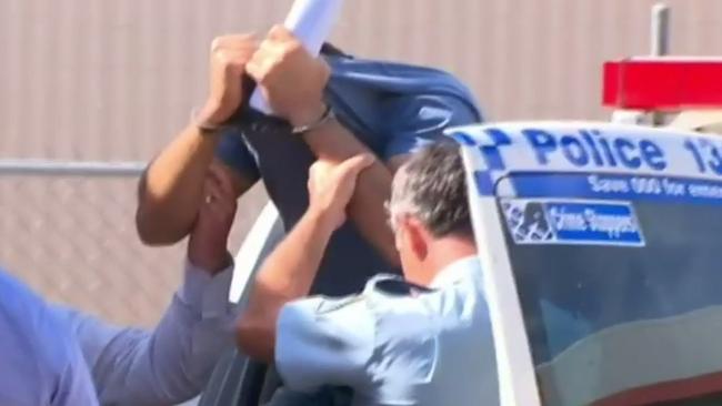 Haisem Zahab in handcuffs after a police raid yesterday. Picture: Nine Network