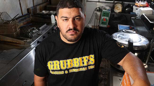 Owner of Grubbies Ben Niuma in his burnt and damaged Strathpine store. Picture: Liam Kidston