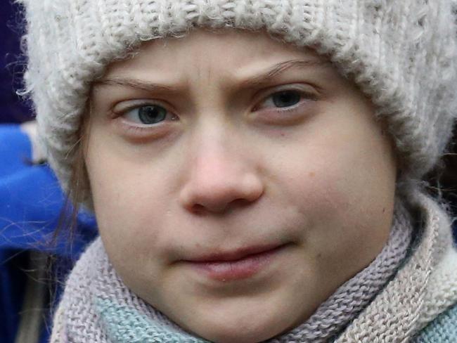 (FILES) In this file photo Swedish environmentalist Greta Thunberg takes part in a protest as she leaves the "Europa building", the headquarters of the EU Council after a meeting of EU environment ministers, in Brussels, on March 5, 2020. - Environmental campaigner Greta Thunberg assailed powerful politicians in biting remarks to a US congressional panel on April 22, 2021, accusing them of "ignoring" the climate crisis and demanding an end to fossil fuel subsidies."How long do you think you can continue ignoring the climate crisis, the global aspect of equity and historic emissions without being held accountable?" the 18-year-old Swede will tell the House Oversight and Reform Committee by remote videolink, according to her prepared remarks. (Photo by FranÃ§ois WALSCHAERTS / AFP)