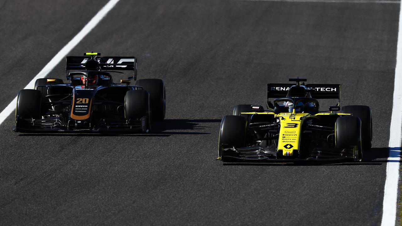 Daniel Ricciardo sweeps past Kevin Magnussen in the race on Sunday. Picture: Mark Thompson