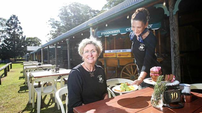 Verandah Cafe waitress Kristin Colless serves owner Sarah Robinson a coffee and some cake. Picture: Scott Powick