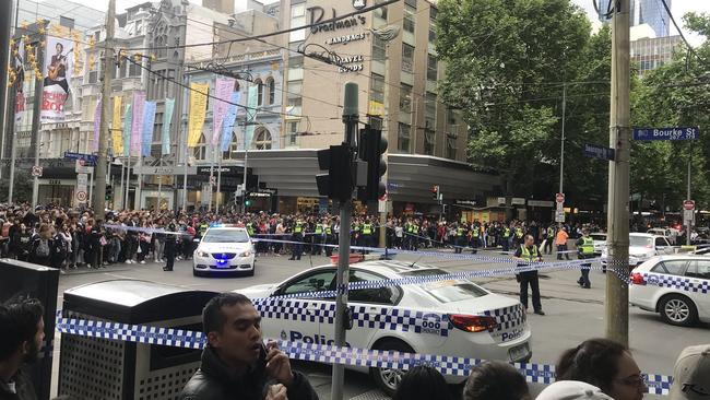 Onlookers near the corner of Swanston and Bourke streets. Picture: Josh Fagan