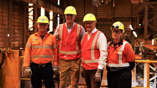 Prime Minister Anthony Albanese (second right) and South Australian Premier Peter Malinauskas (second left) pose for a photograph with workers inside the Whyalla steelworks in Whyalla.