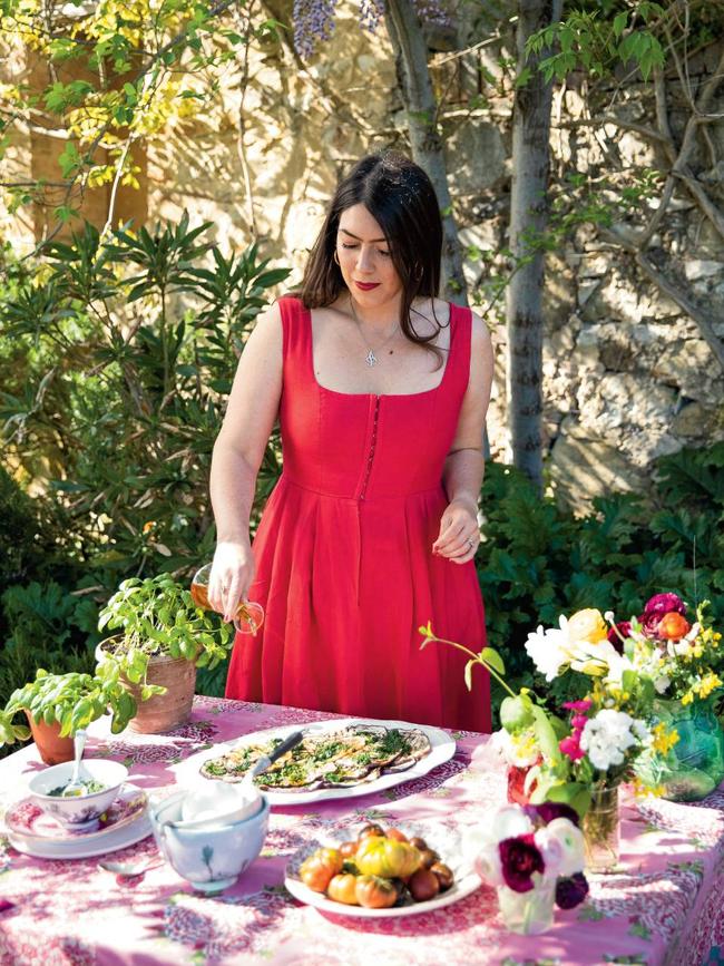 Amber Guinness puts the finishing touches on a dish of grilled aubergines with summery green sauce. Photo: Robyn Lea