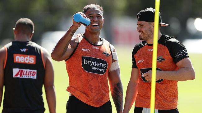 Josh Reynolds, right, shares a joke at Tigers training on Wednesday. Picture: Getty Images