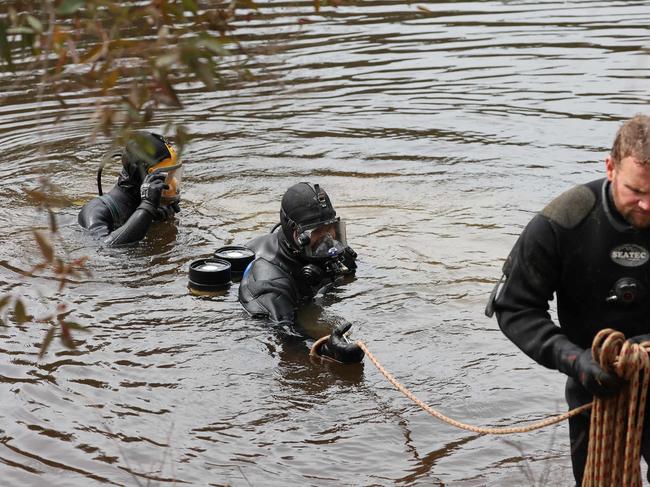 Divers search waterways for any trace of the missing boy. Picture: David Swift