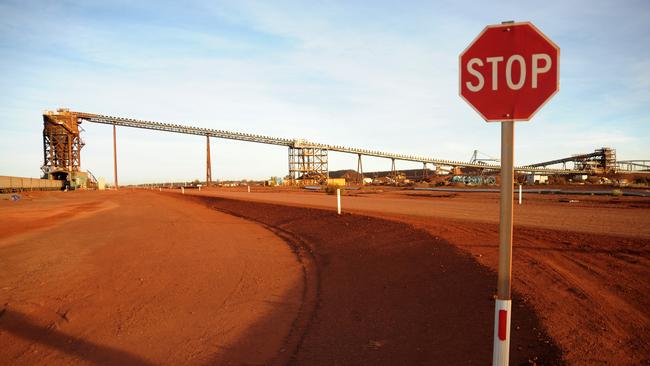 A stop sign stands at the entrance to the crushing facility at Fortescue Metals Group, Cloudbreak Iron Ore operation in Cloudbreak in Western Australia, on Monday, Jul. 25, 2011. Photographer: Carla Gottgens/Bloomberg