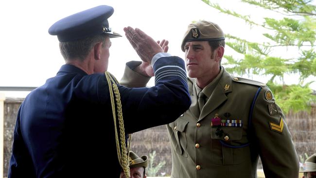 Chief of the Defence Force, Air Chief Marshal Angus Houston (left), salutes Australian Army soldier Corporal Ben Roberts-Smith, VC, MG, during the Victoria Cross for Australia investiture ceremony at Campbell Barracks, Perth, in 2011.