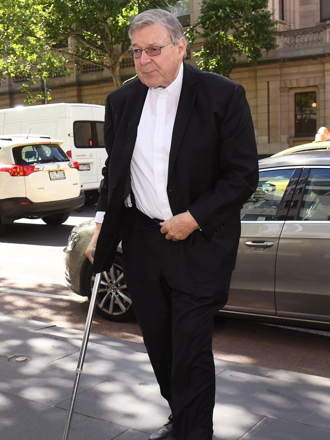 George Pell using a walking stick outside a Melbourne court.