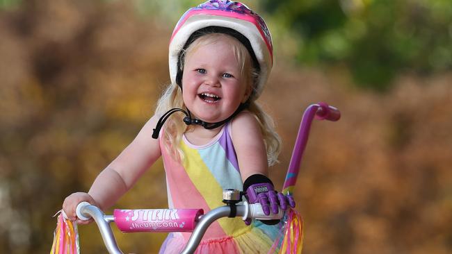 Izabella Carlson, 3, can now ride her bike with her new 3D printed hand. Pics Adam Head