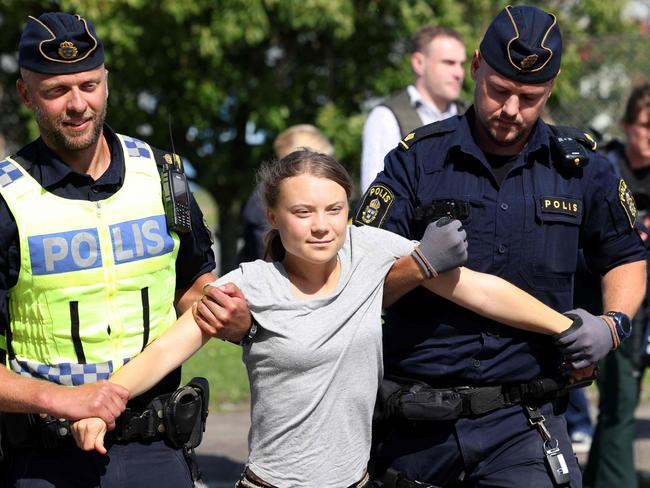 Climate activist Greta Thunberg is carried away by police officers after protesting in Oljehamnen in Malmo, Sweden, on July 24, 2023. She took part in the protest shortly after the city's district court convicted and fined her for disobeying police at a rally last month. Thunberg said she acted out of necessity due to the climate crisis. Picture: Andreas Hillergren / TT News Agency / AFP