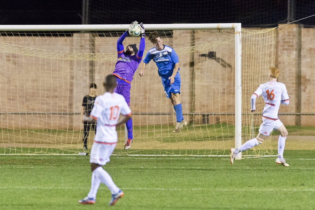 Lions FC keeper Luke Borean gets to the ball in front of Lathan Dunn of South West Queensland Thunder against Lions FC in NPL Queensland men round 22 football at Clive Berghofer Stadium, Saturday, July 28, 2018. Picture: Kevin Farmer