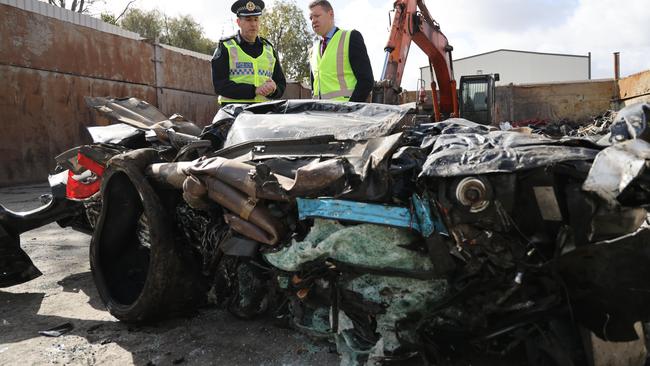 Superintendent Darren Fielke and Police Minister Joe Szakacs inspect what’s left of the ute. Picture: NCA NewsWire/David Mariuz