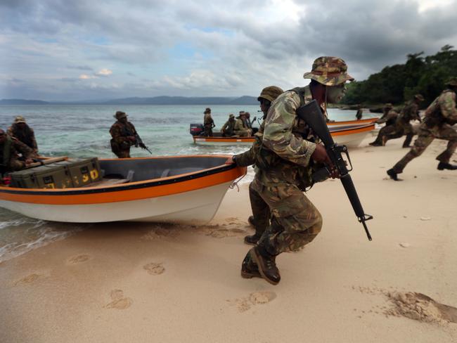 Aussie diggers with PNG soldiers during an exercise in amphibious operations exercise. Picture Gary Ramage