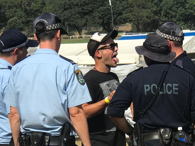 **NO BYLINE PLEASE**26/01/2019: Police question a man at the Electric Garden festival in Centennial Park. The Australian