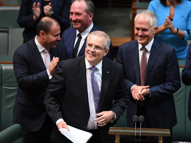 Australian Federal Treasurer Scott Morrison is congratulated by (lt-rt) Minister for Environment Josh Frydenberg, Deputy Prime Minister Barnaby Joyce, Prime Minister Malcolm Turnbull and Minister for Defence Materials christoper Pyne after delivering of the 2017-18 Federal Budget in the House of Representatives at Parliament House in Canberra, Tuesday, May 9, 2017. (AAP Image/Dean Lewins) NO ARCHIVING