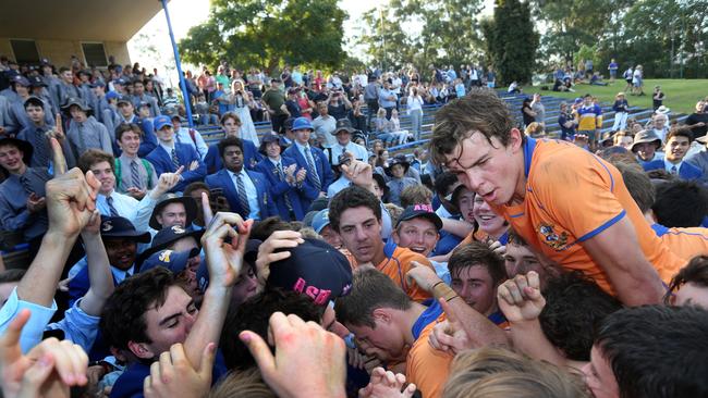 Marist College Ashgrove’s Max Mee crowd surfs after winning the title last season. (AAP Image/Richard Waugh)