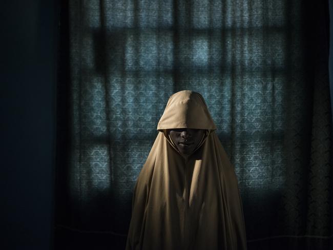 Aisha, age 14, stands for a portrait in Maiduguri, Borno State, Nigeria on Sept. 21, 2017. Aisha was kidnapped by Boko Haram then assigned a suicide bombing mission. After she was strapped with explosives, she found help instead of blowing herself and others up. Picture: Adam Ferguson for The New York Times/World Press Photo