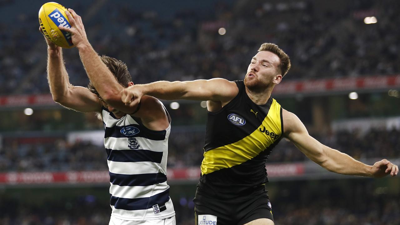 Tom Hawkins (5 goals) marks in front of Richmond defender Noah Balta on Friday night. Picture: Dylan Burns/AFL Photos