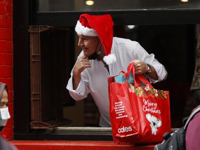 Former Lord Mayor Robert Doyle handing out gifts. Picture: Alex Coppel