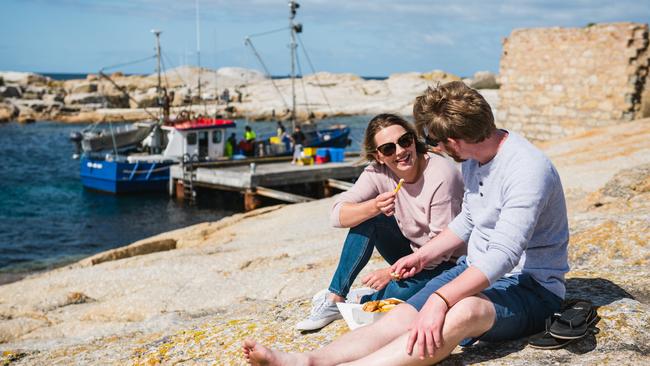 Enjoying fish and chips at Bicheno. Picture: Stu Gibson