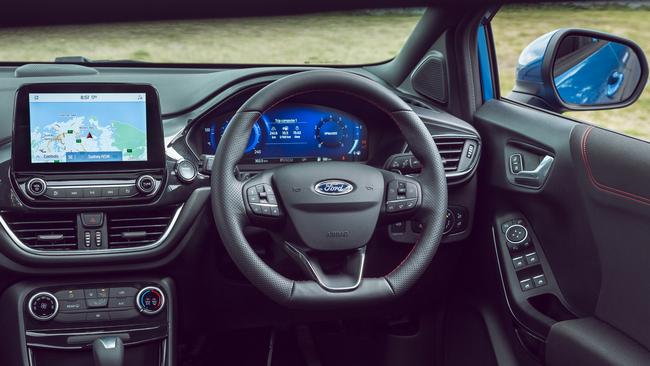 The interior has a sporty look, with a flat-bottomed steering wheel and red stitching. Picture: Supplied.