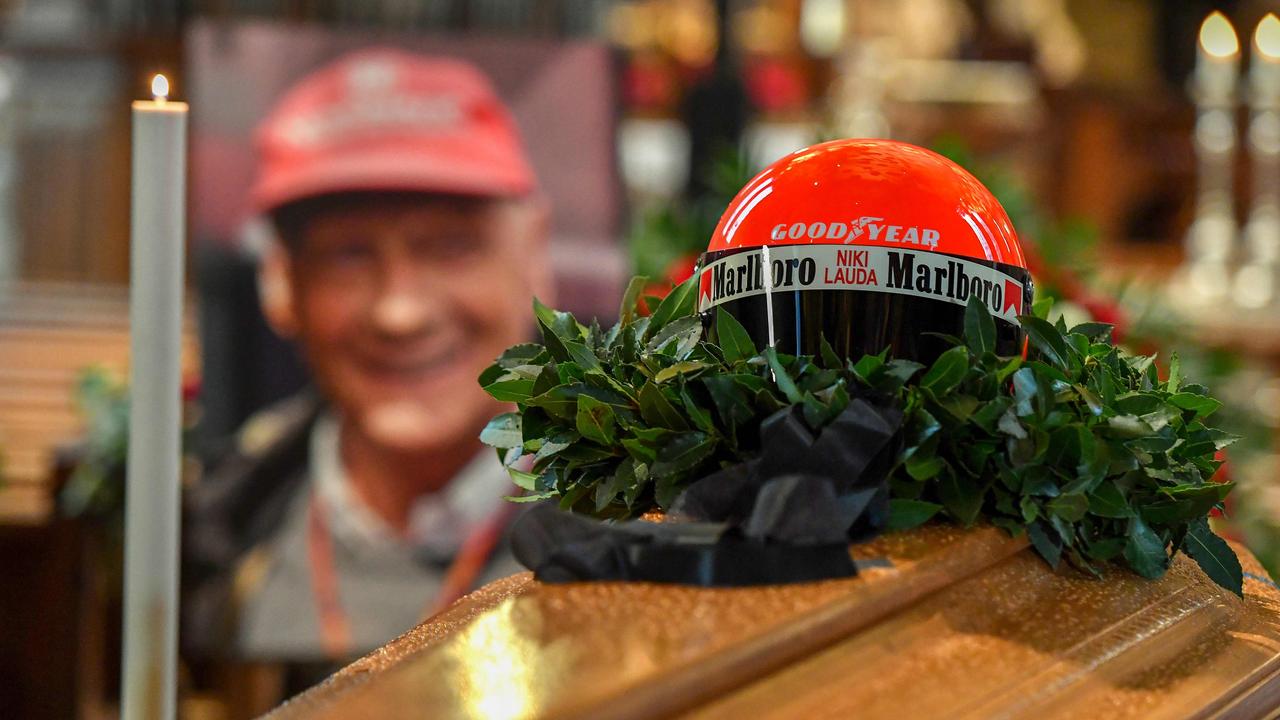 The helmet of Niki Lauda sits on top of his coffin and next to his portrait.